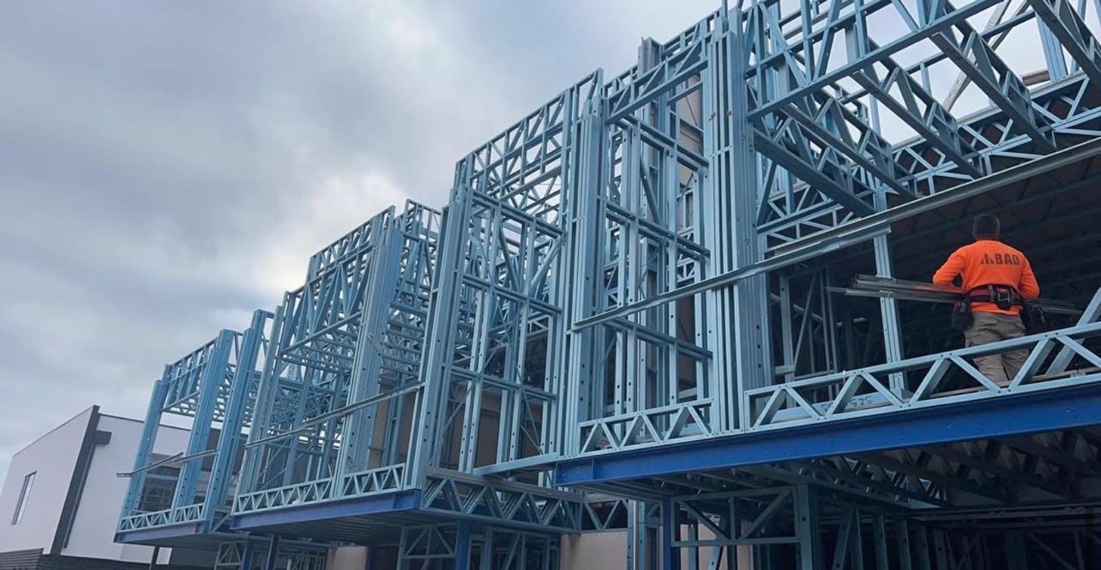 Upper-level steel wall frames and floor trusses installed on a multi-unit build in Victoria