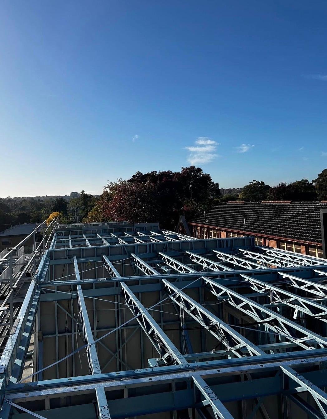 Steel roof trusses installed over the top level of an apartment build in Victoria